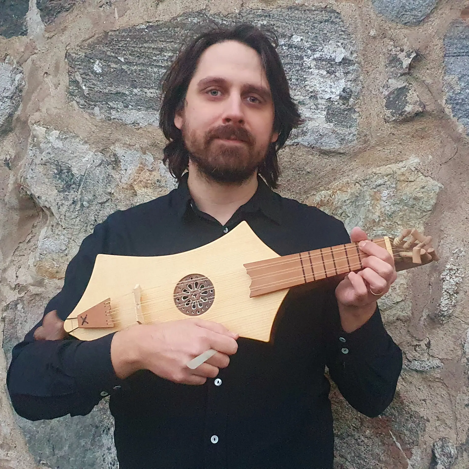 Musician playing medieval citole